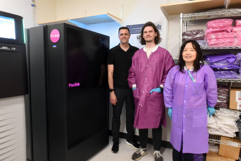 picture of three people from Maryland Genomics standing in front of a PacBio Revio system